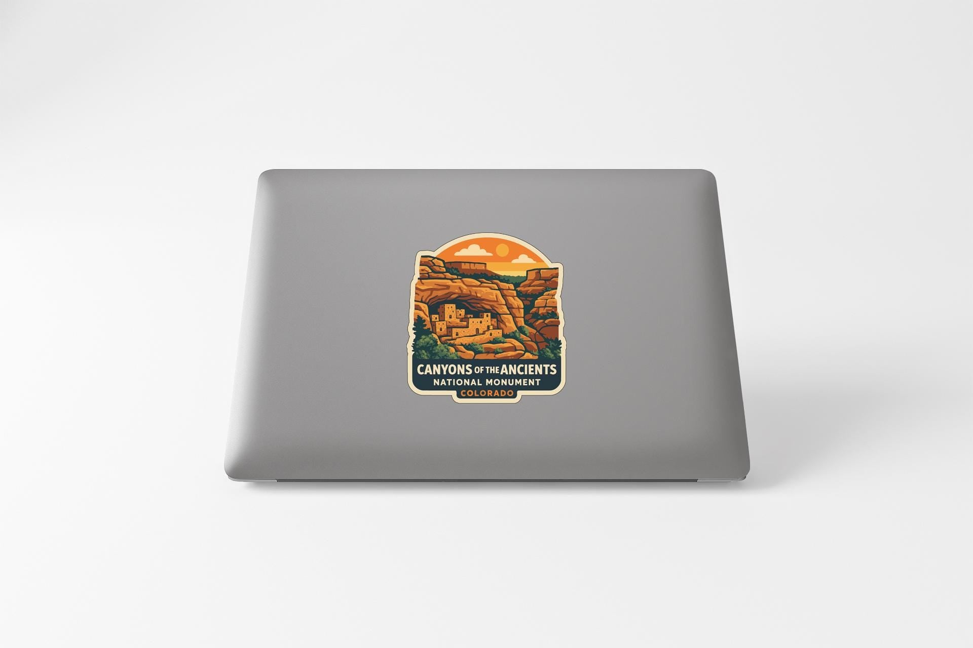 a sticker or decal of the Canyon of the Ancients National Monument on a laptop computer.