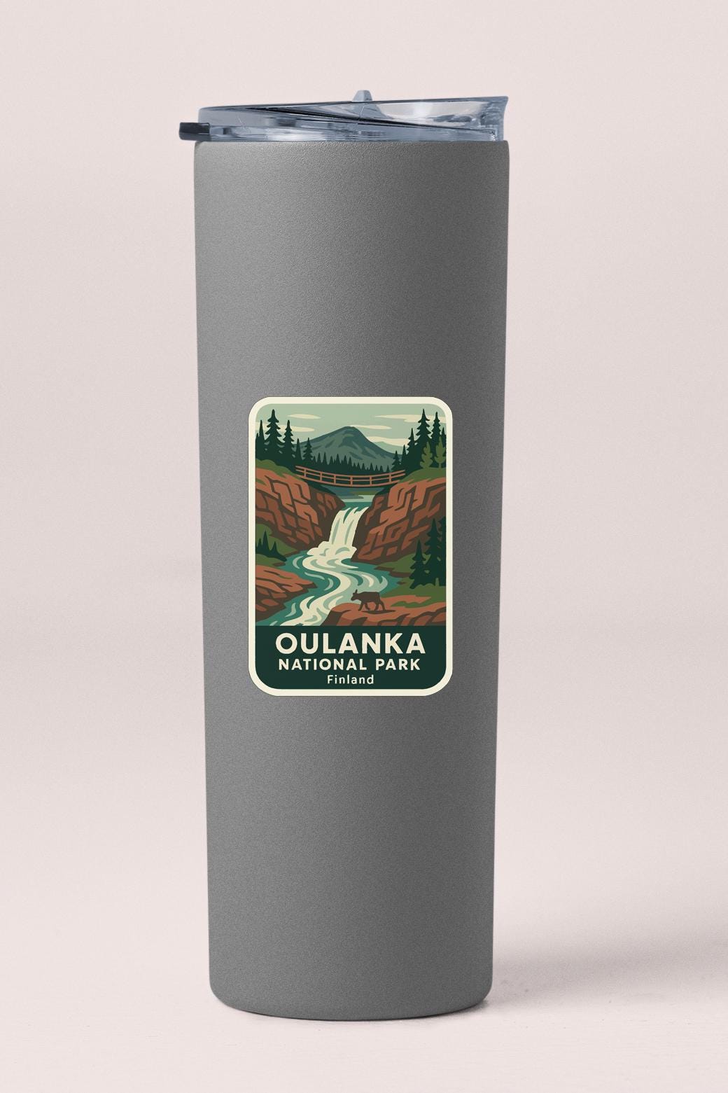 A gray insulated tumbler with a label that features a scenic illustration of Oulanka National Park in Finland.