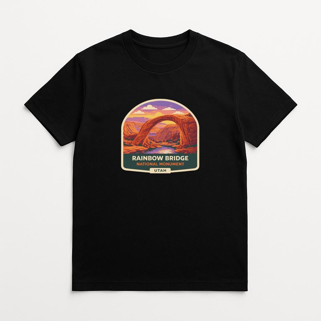 A black t-shirt with a graphic design depicting the Rainbow Bridge in Utah.