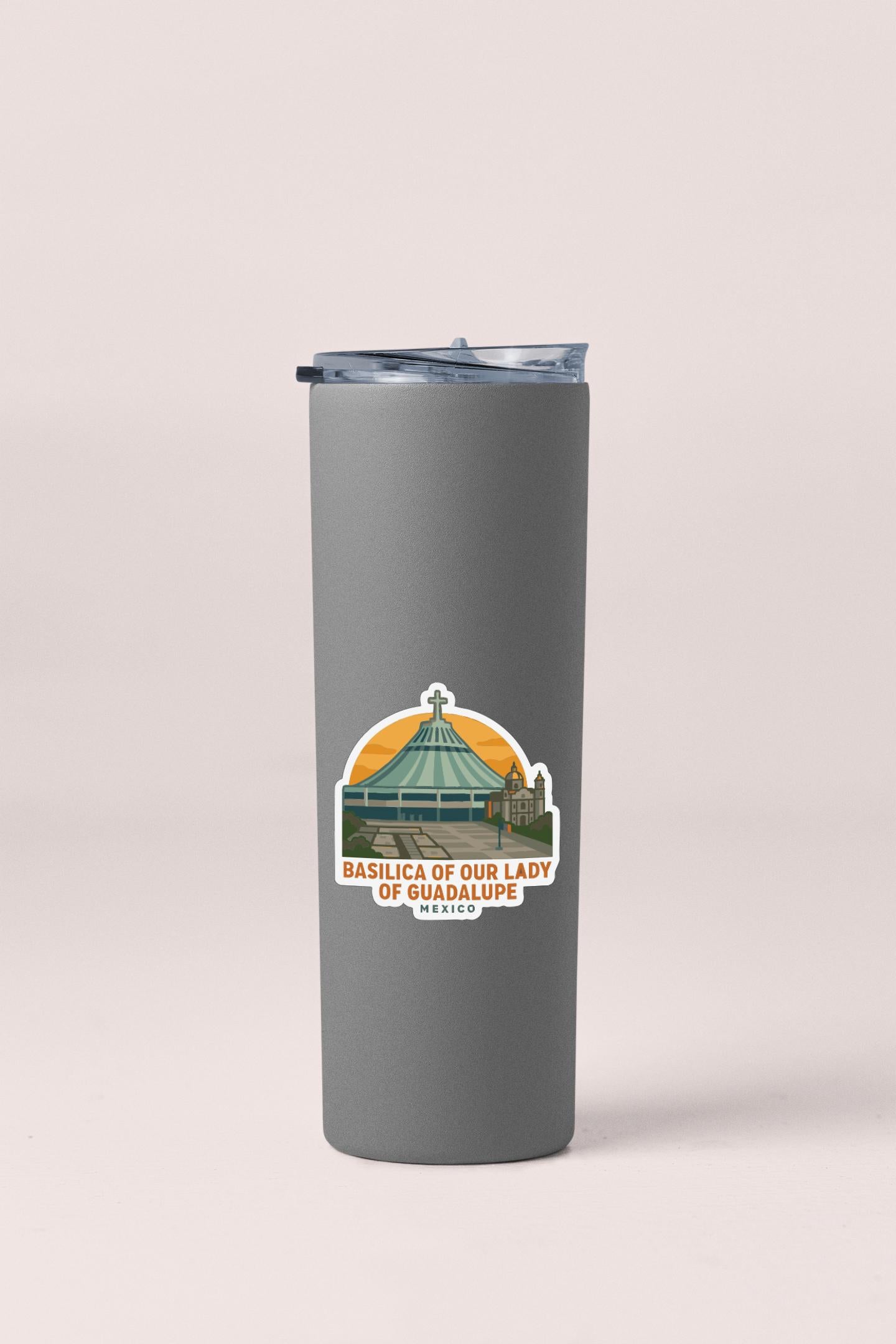 A gray insulated tumbler with a sticker depicting the Basilica of Our Lady of Guadalupe in Mexico.