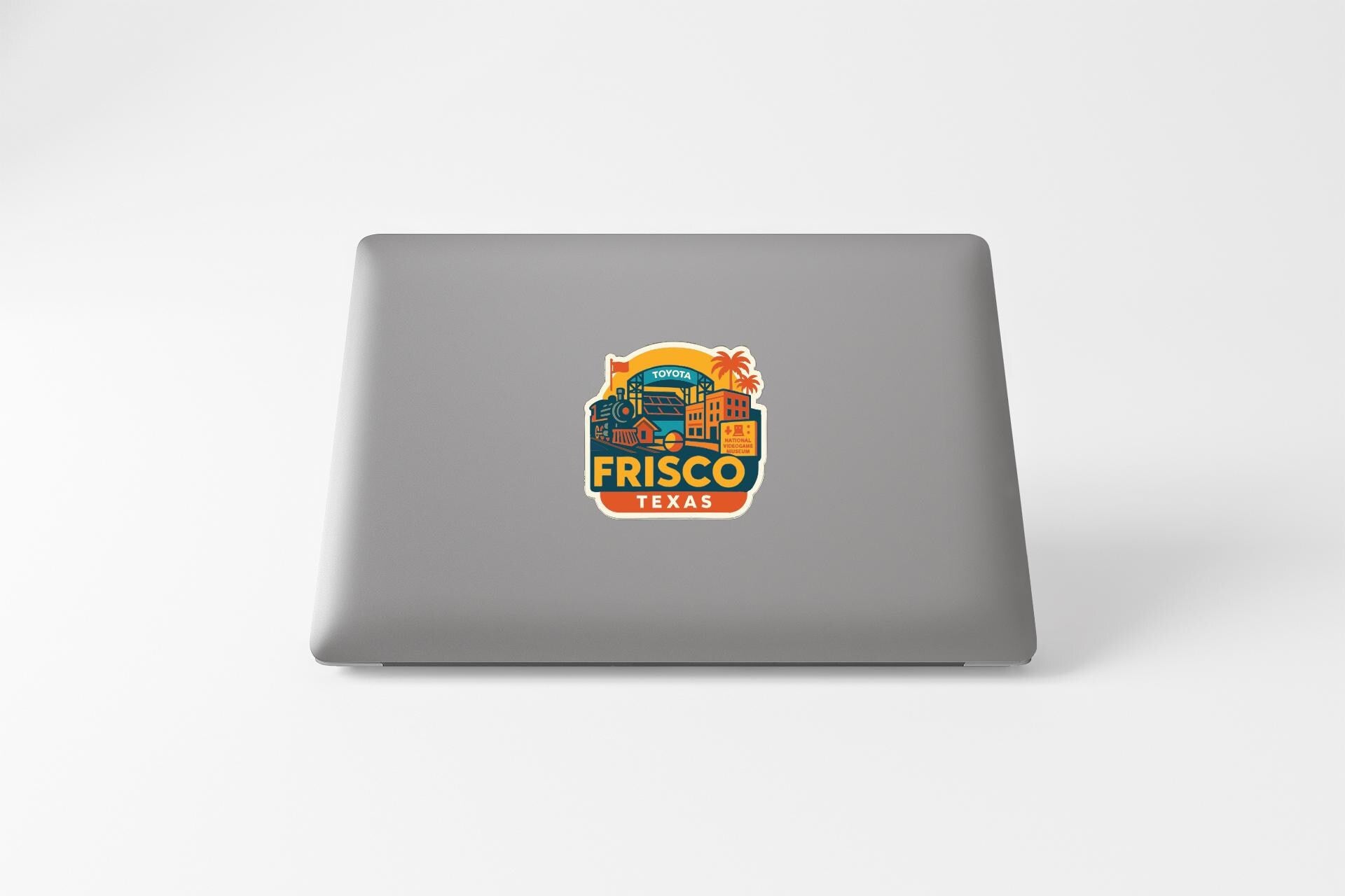 a sticker or decal on the back of a laptop, depicting a cityscape with various buildings and landmarks.