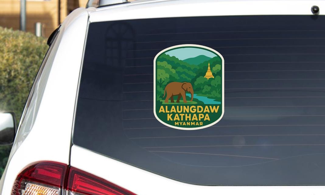 a sticker on the rear window of a car, depicting a scenic landscape with a temple in the background.