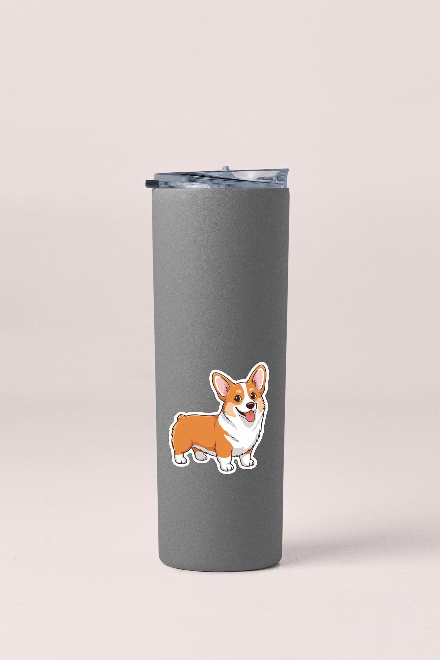 A gray insulated tumbler with a sticker of a corgi dog on it.