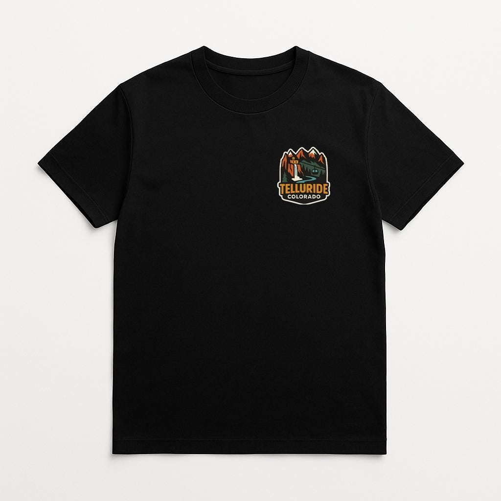 A black t-shirt with a graphic design on the front, featuring a mountain landscape and the text "Yellowknife" printed on it.