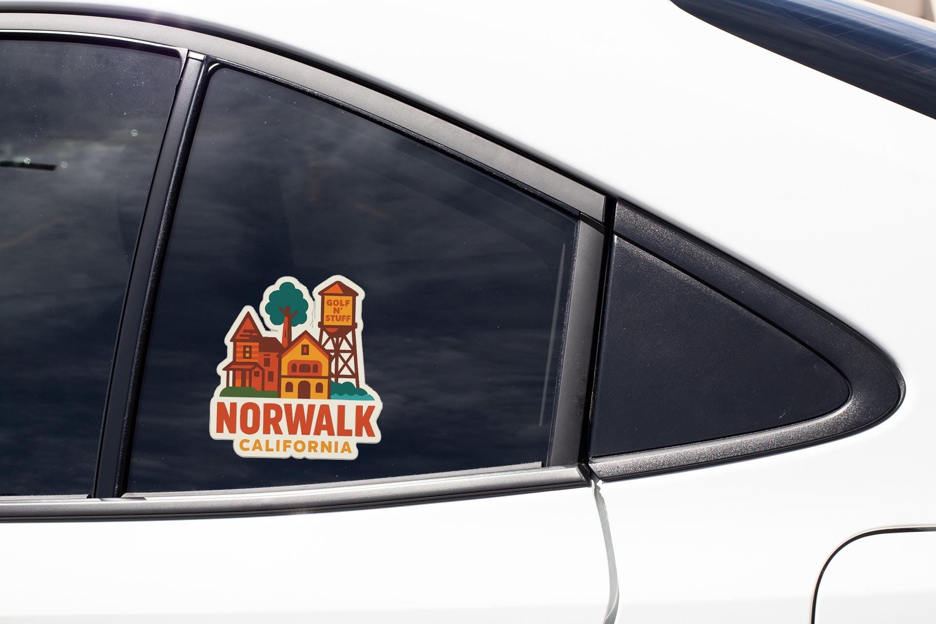 A sticker on the side of a car window that says "NORWALK CALIFORNIA".