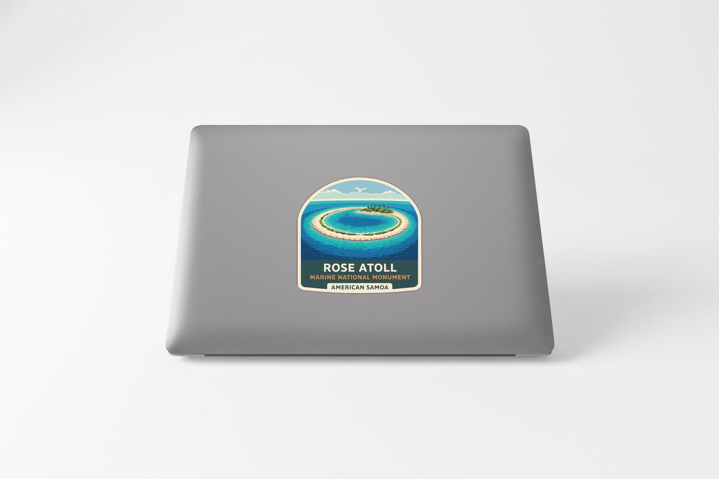 a sticker on a laptop with a tropical island and ocean scene.