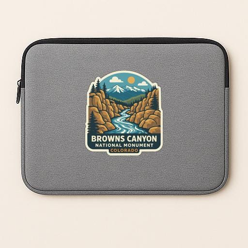 A gray laptop sleeve with a sticker depicting the scenic landscape of Browns Canyon National Monument in Colorado.