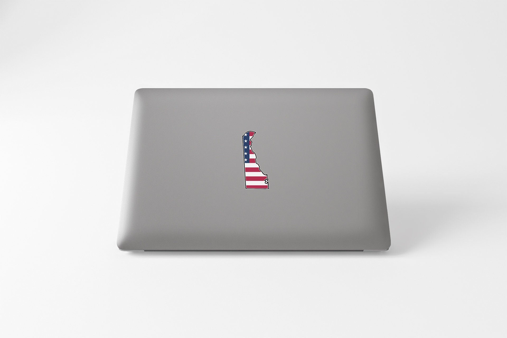 a laptop with a sticker of a flag on it