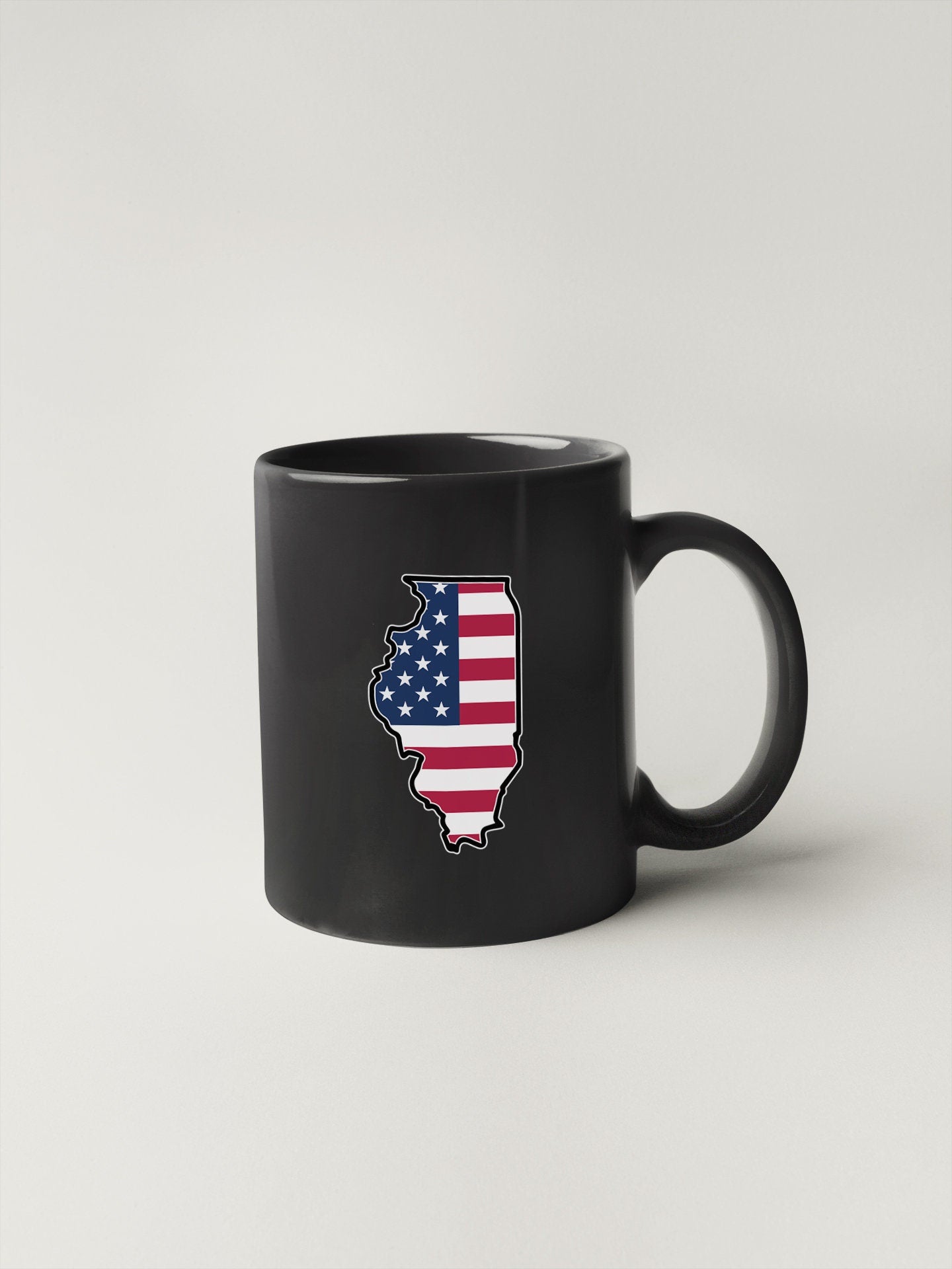 a black coffee mug with an american flag on it