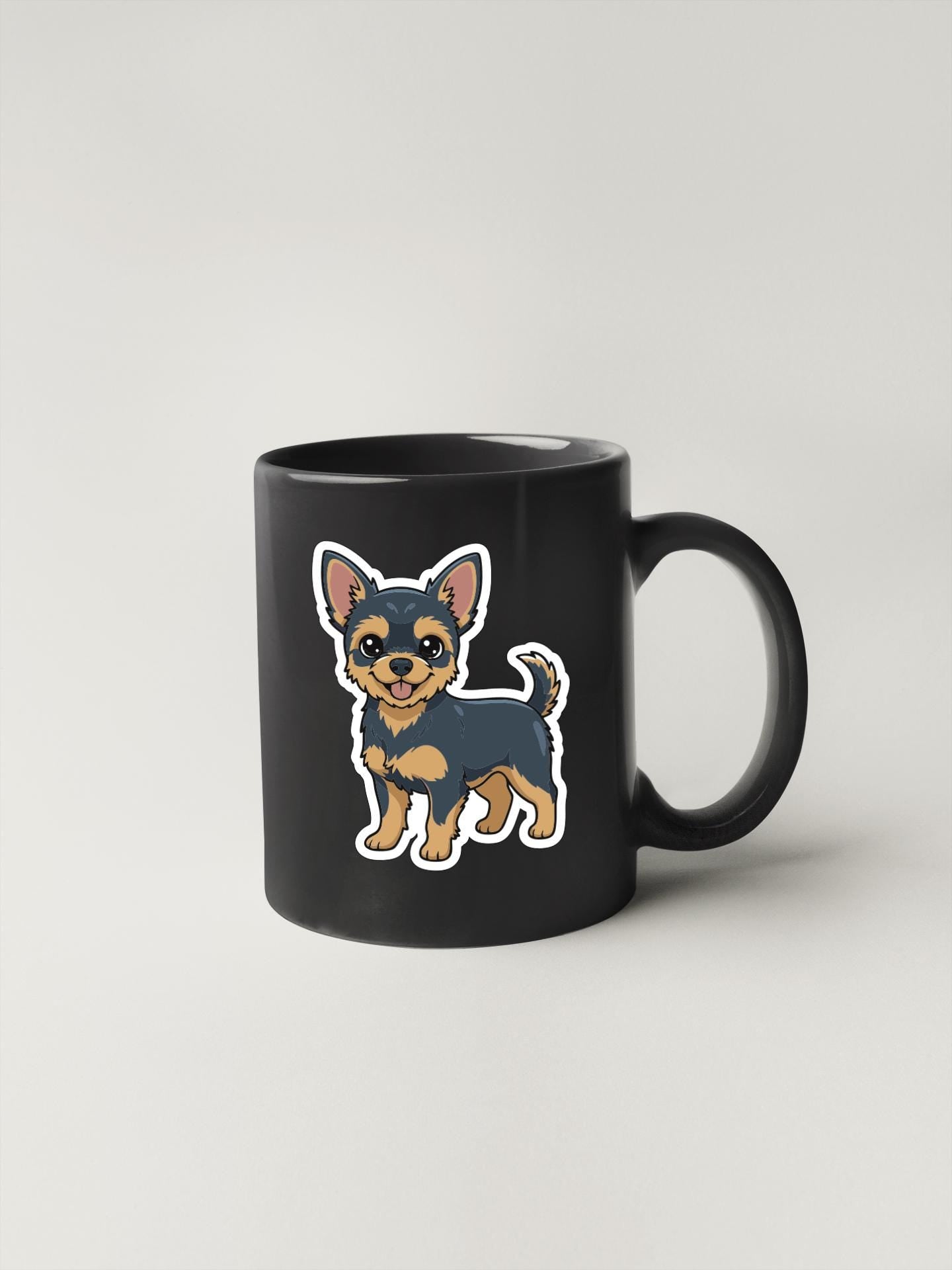 A black coffee mug with a cartoon illustration of a small dog on it.