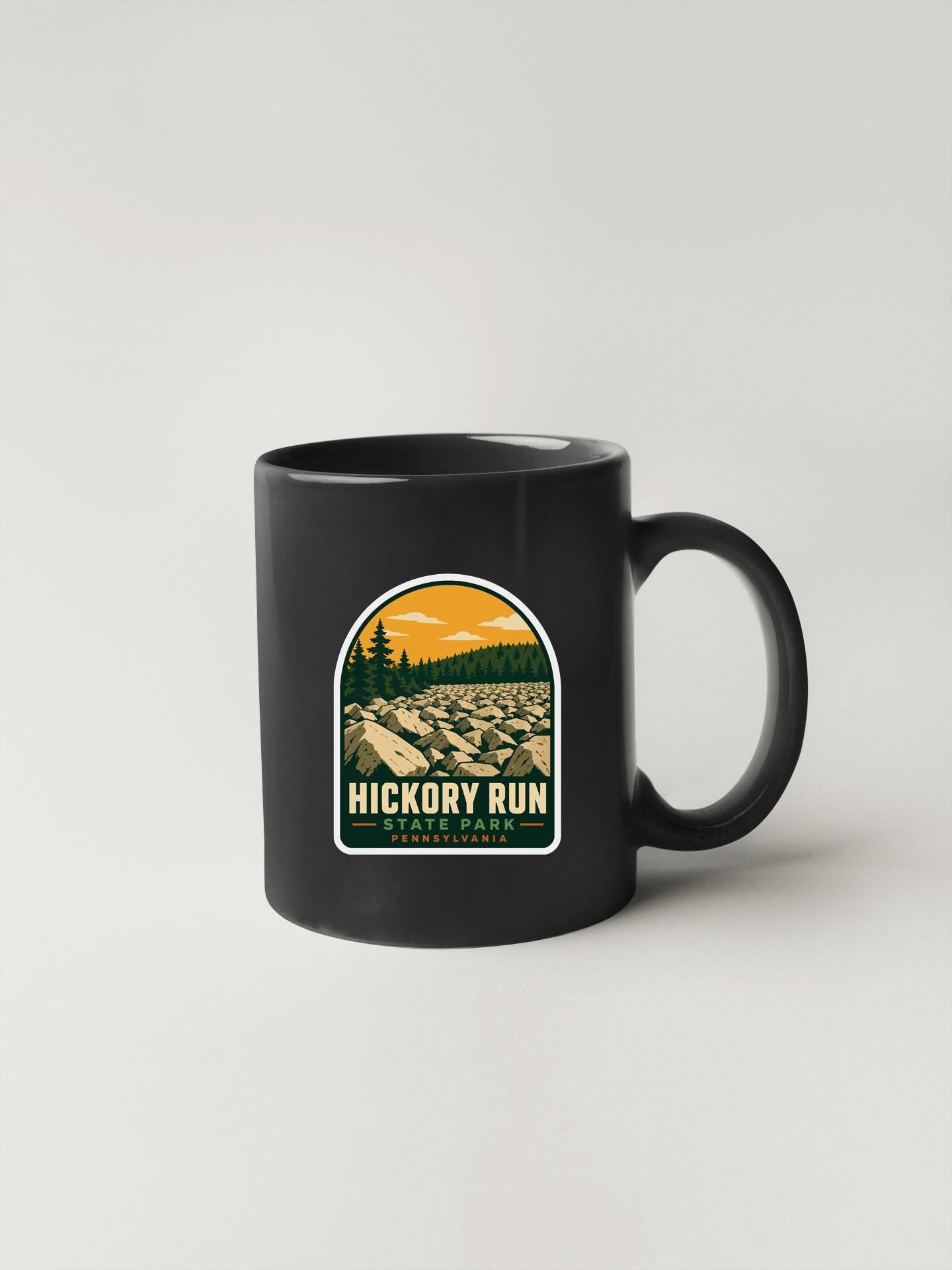A black coffee mug with a graphic design featuring a mountain landscape and the text "HICKORY RUN" and "PENNSYLVANIA".