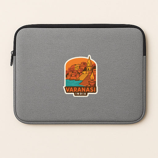 A gray laptop sleeve with a sticker depicting a cityscape and the text "VARANASI INDIA".