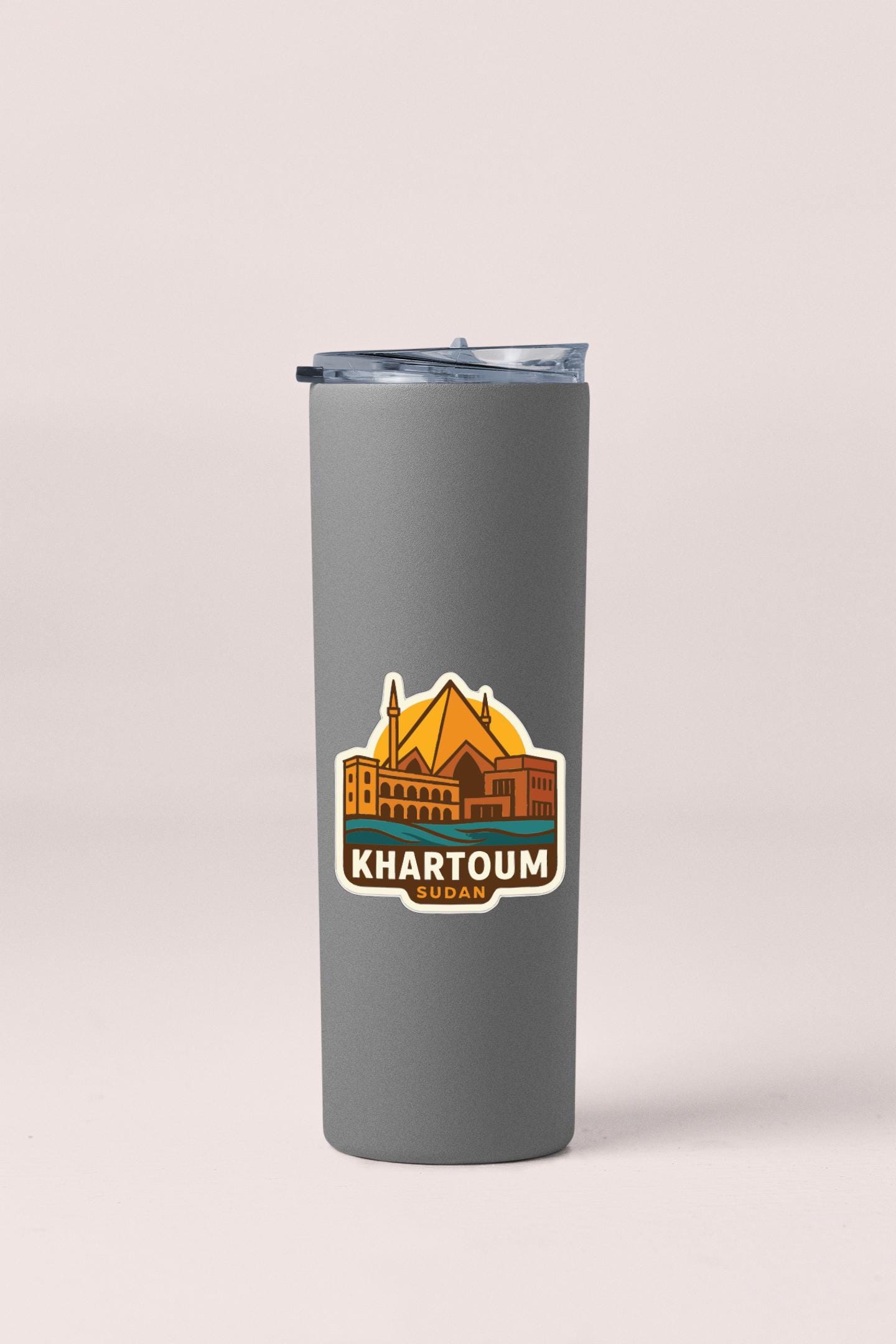 A gray insulated tumbler with a sticker featuring an illustration of Khartoum, the capital city of Sudan.