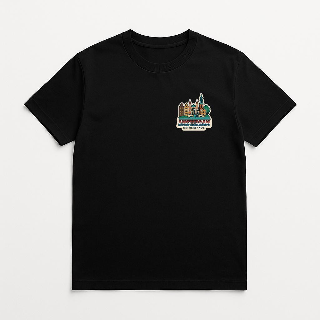 A black t-shirt with a colorful graphic design on the front, depicting a cityscape with buildings and trees.
