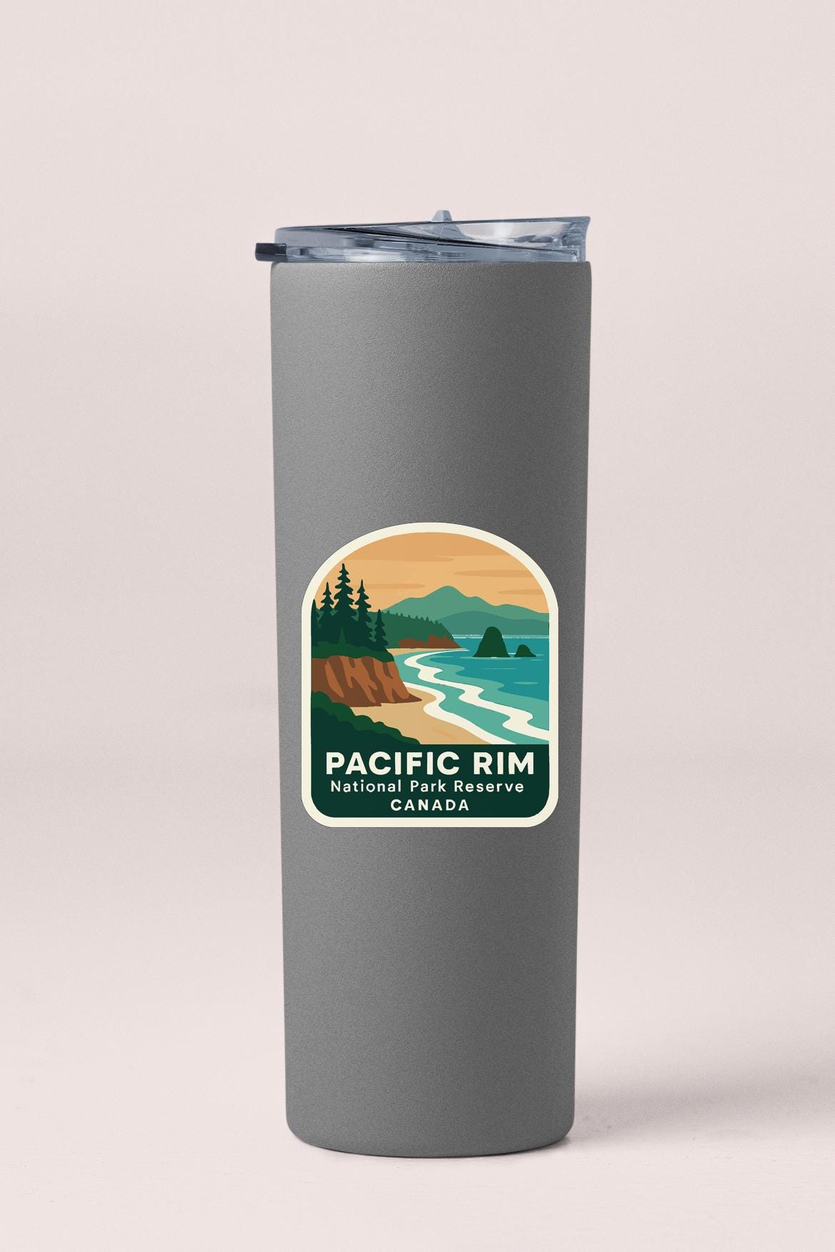 A gray insulated tumbler with a label that features a scenic landscape of the Pacific Rim National Park Reserve in Canada.