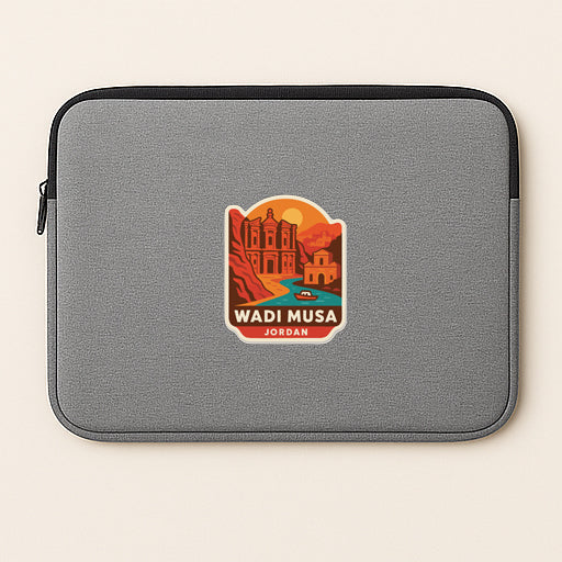 A gray laptop sleeve with a sticker depicting a scenic view of Wadi Musa, a famous landmark in Jordan.