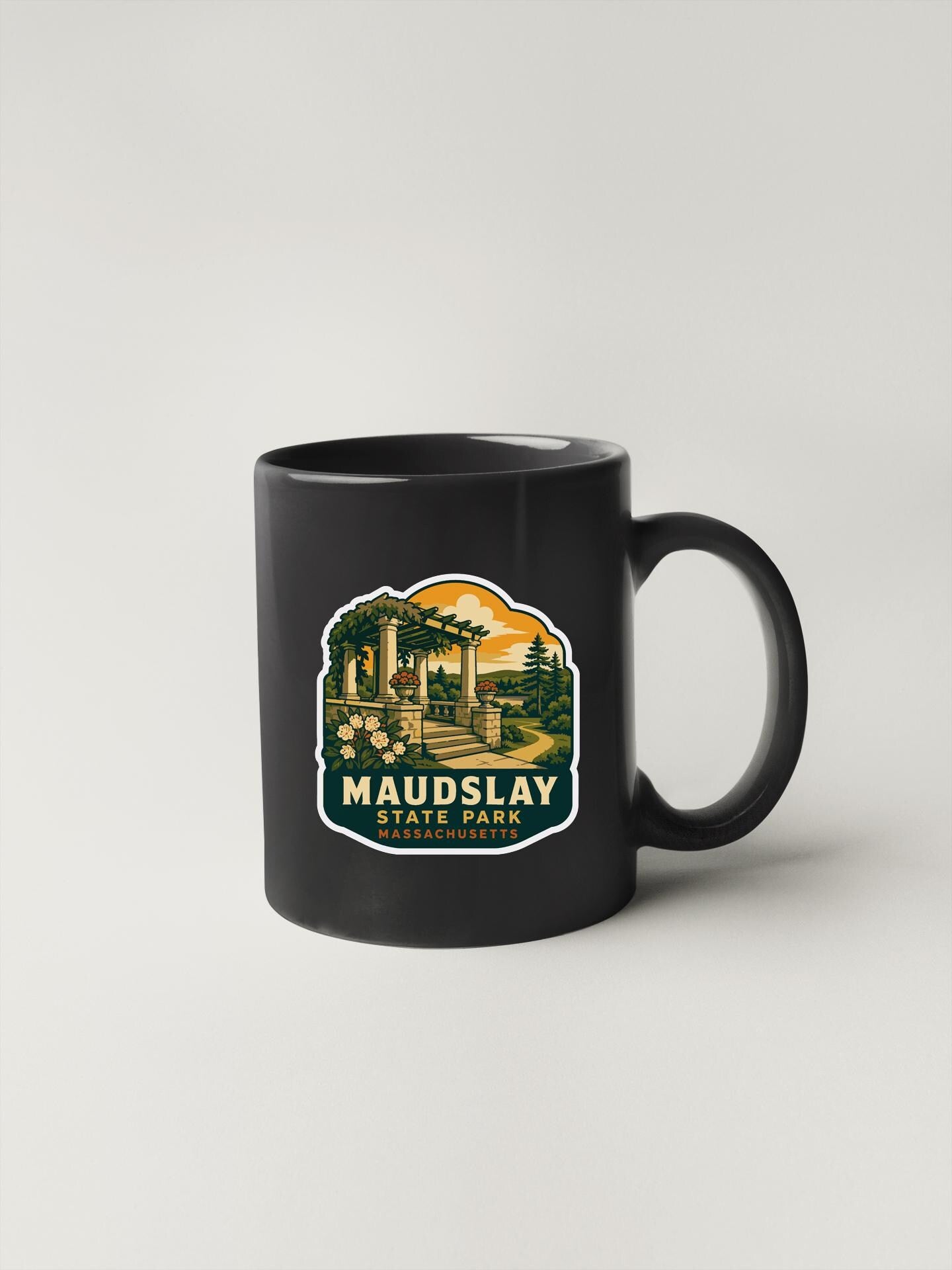 A black coffee mug with a graphic design depicting a scenic landscape, including a palm tree, a building, and a sunset.