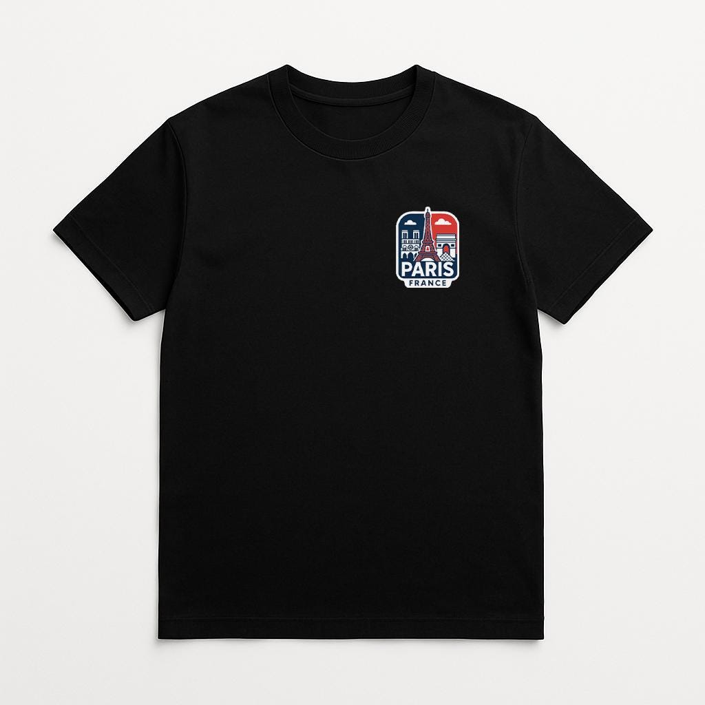 A black t-shirt with a graphic design on the front, featuring the Eiffel Tower and the word "PARIS" in a stylized font.
