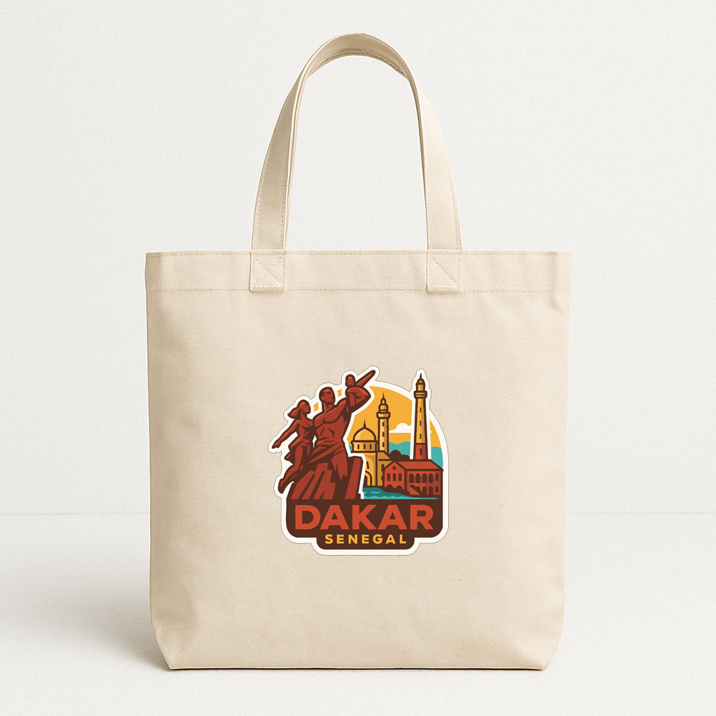 A beige tote bag with a graphic design featuring a cityscape and the text "DAKAR SENEGAL".