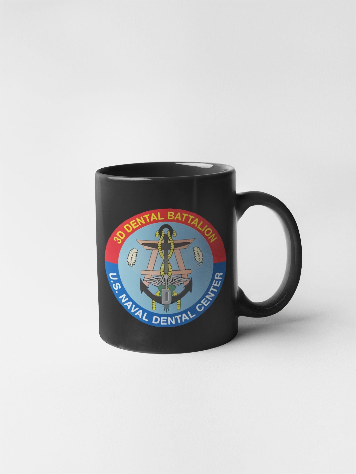 a black coffee mug with a picture of a woman on it