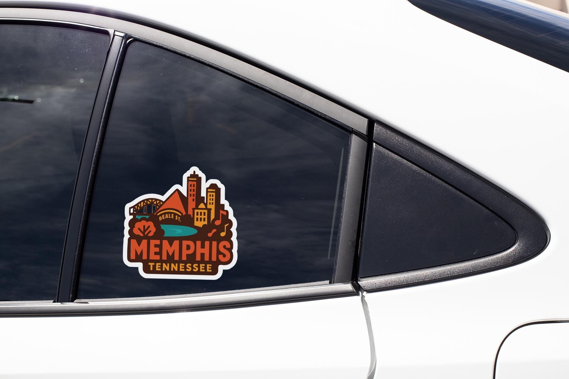 A car window sticker with the text "Memphis, Tennessee" and an illustration of a city skyline.