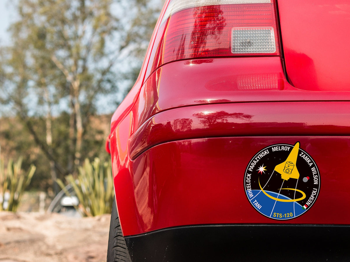 a close up of a red car with a sticker on it