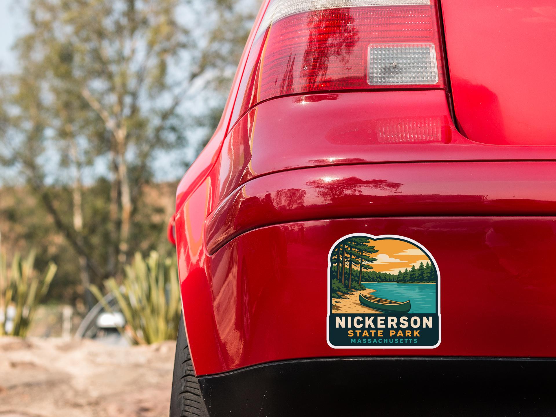 the rear end of a red car with a sticker on the back window that says "NICKERSON STATE PARK WASHINGTON".