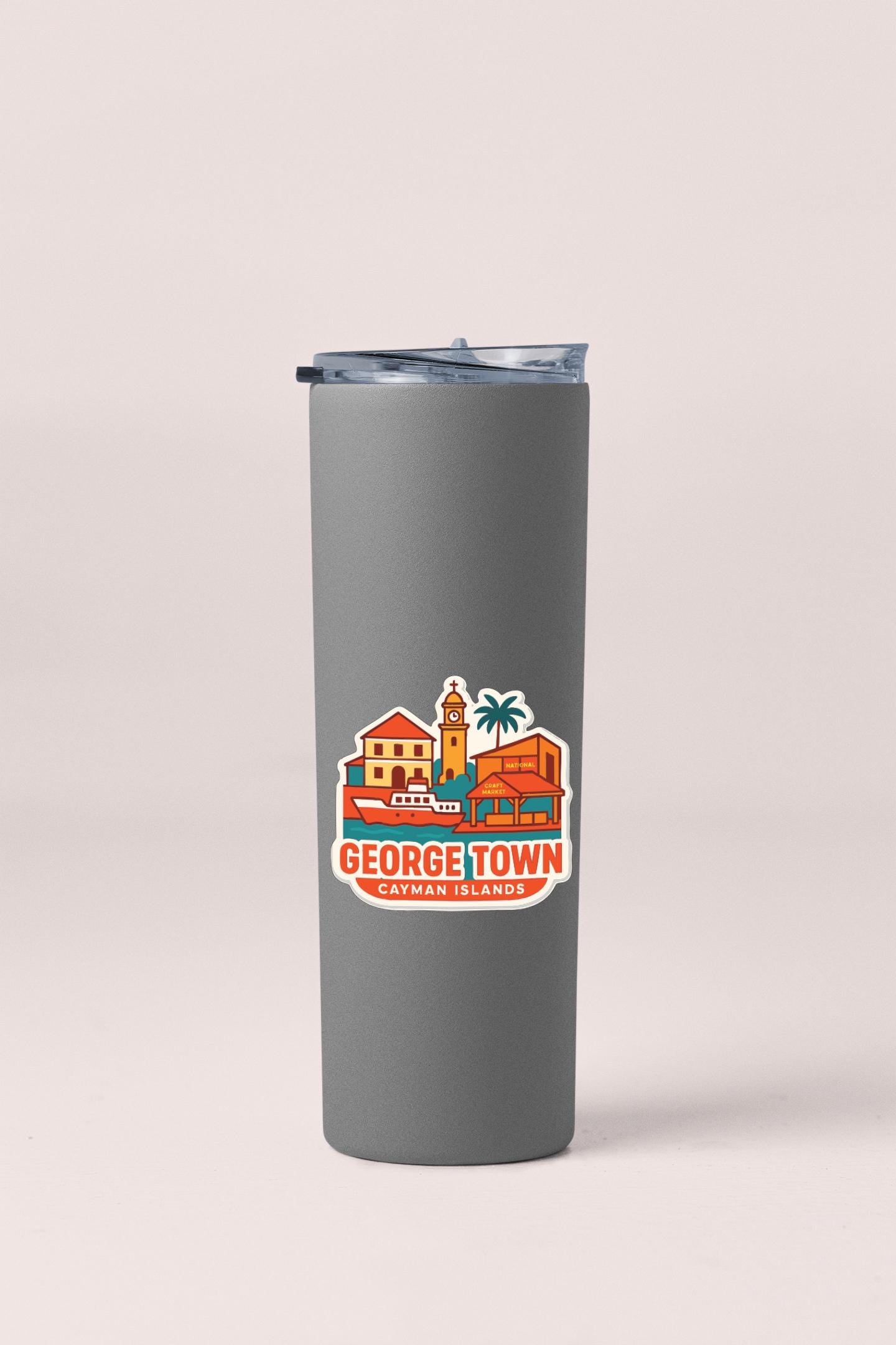 A gray insulated tumbler with a sticker depicting a colorful illustration of a town or city.