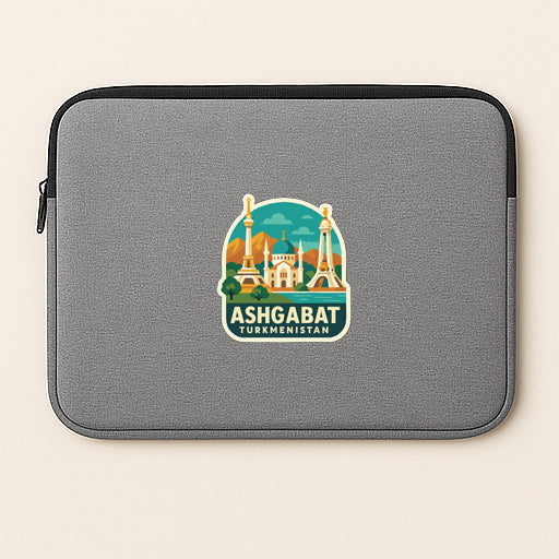 A gray laptop sleeve with a sticker of the Taj Mahal and the text "ASHGABAT TURKMENISTAN" printed on it.