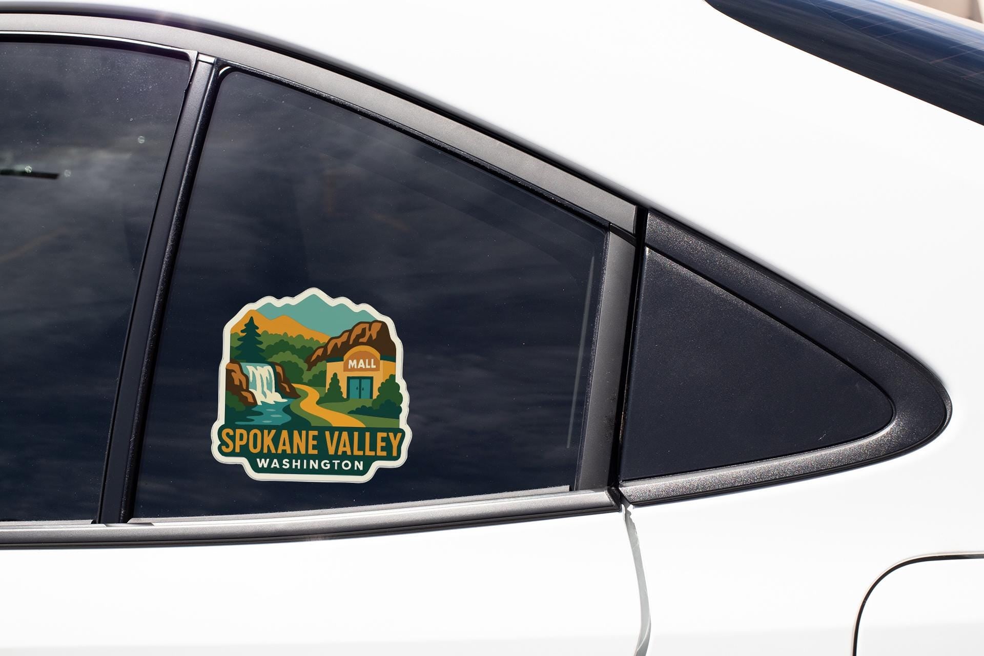 A sticker on the side of a car window, depicting a scenic view of Spokane Valley, Washington.