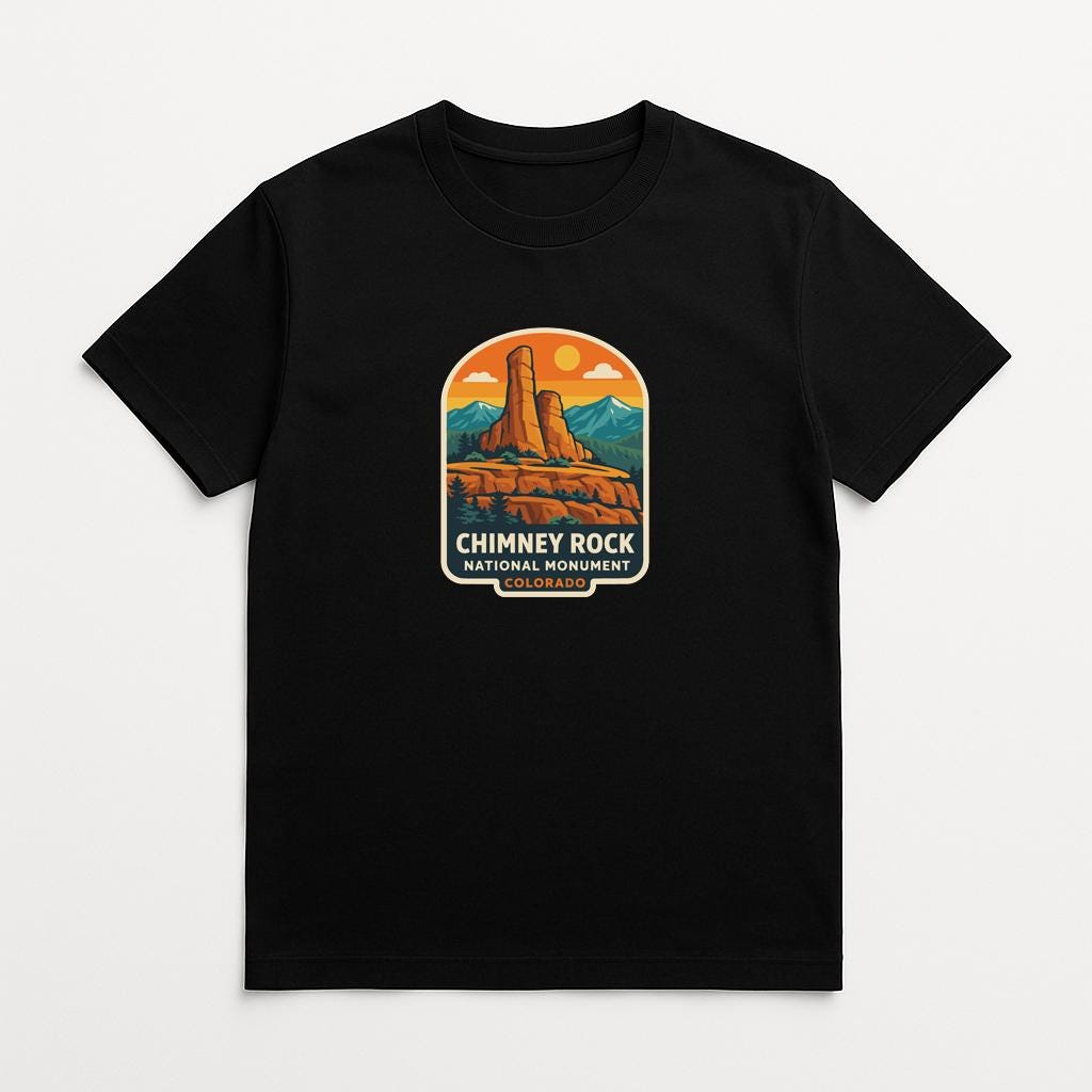 A black t-shirt with a graphic design depicting the Chimney Rock National Monument in Colorado.