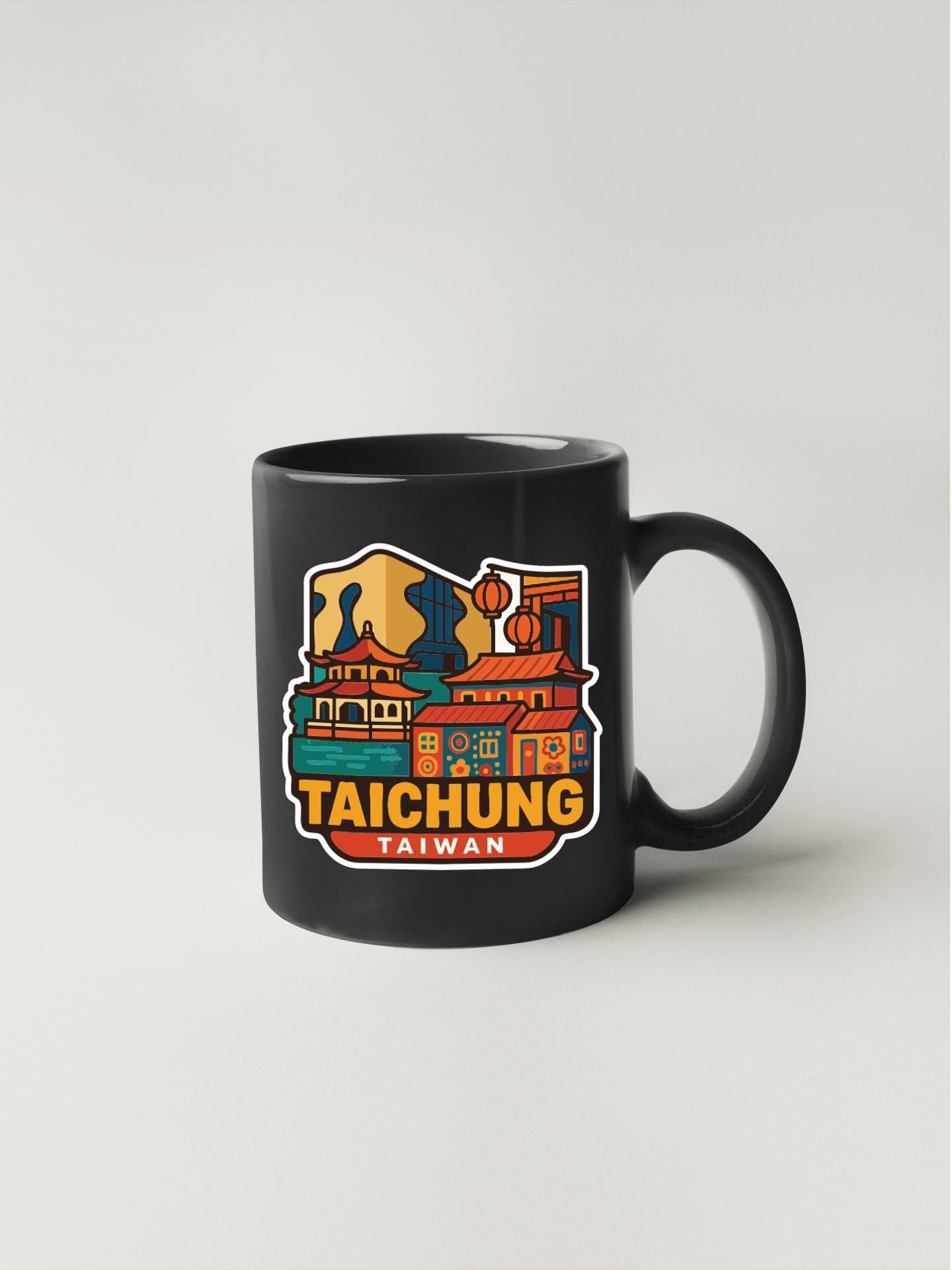 A black coffee mug with a colorful illustration of a cityscape and the text "TAIHCHUNG TAIWAN" printed on it.