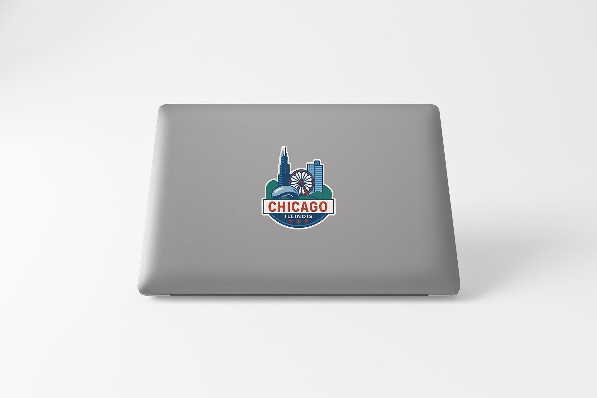 a laptop with a chicago skyline sticker on it