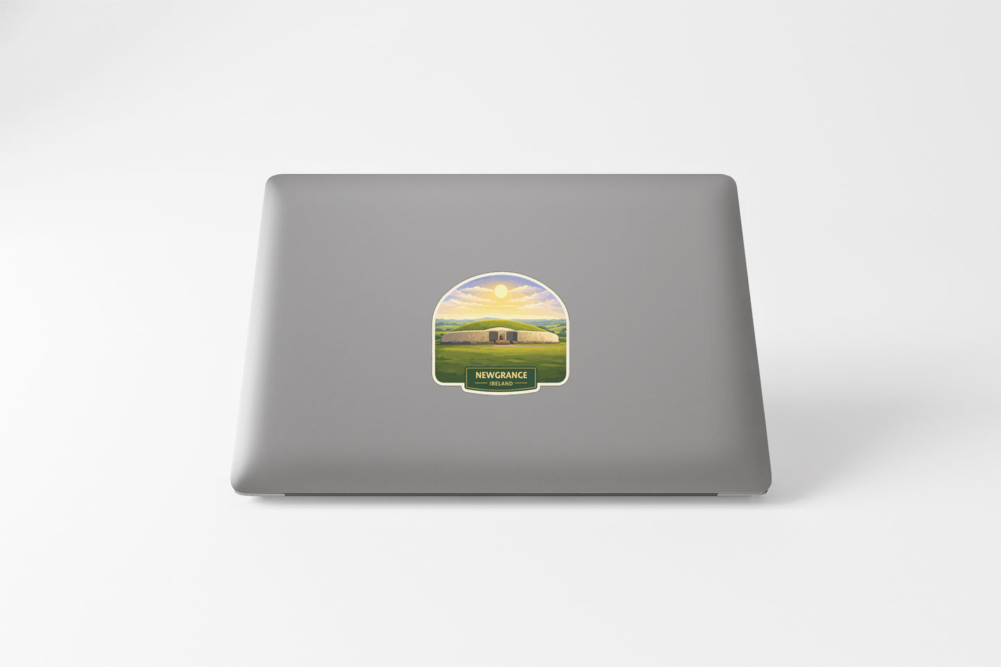 a sticker with a landscape scene on a laptop.