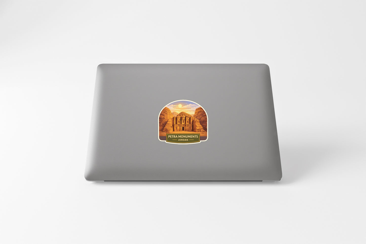 a sticker with an illustration of a building, likely a landmark, on the back of a laptop computer.