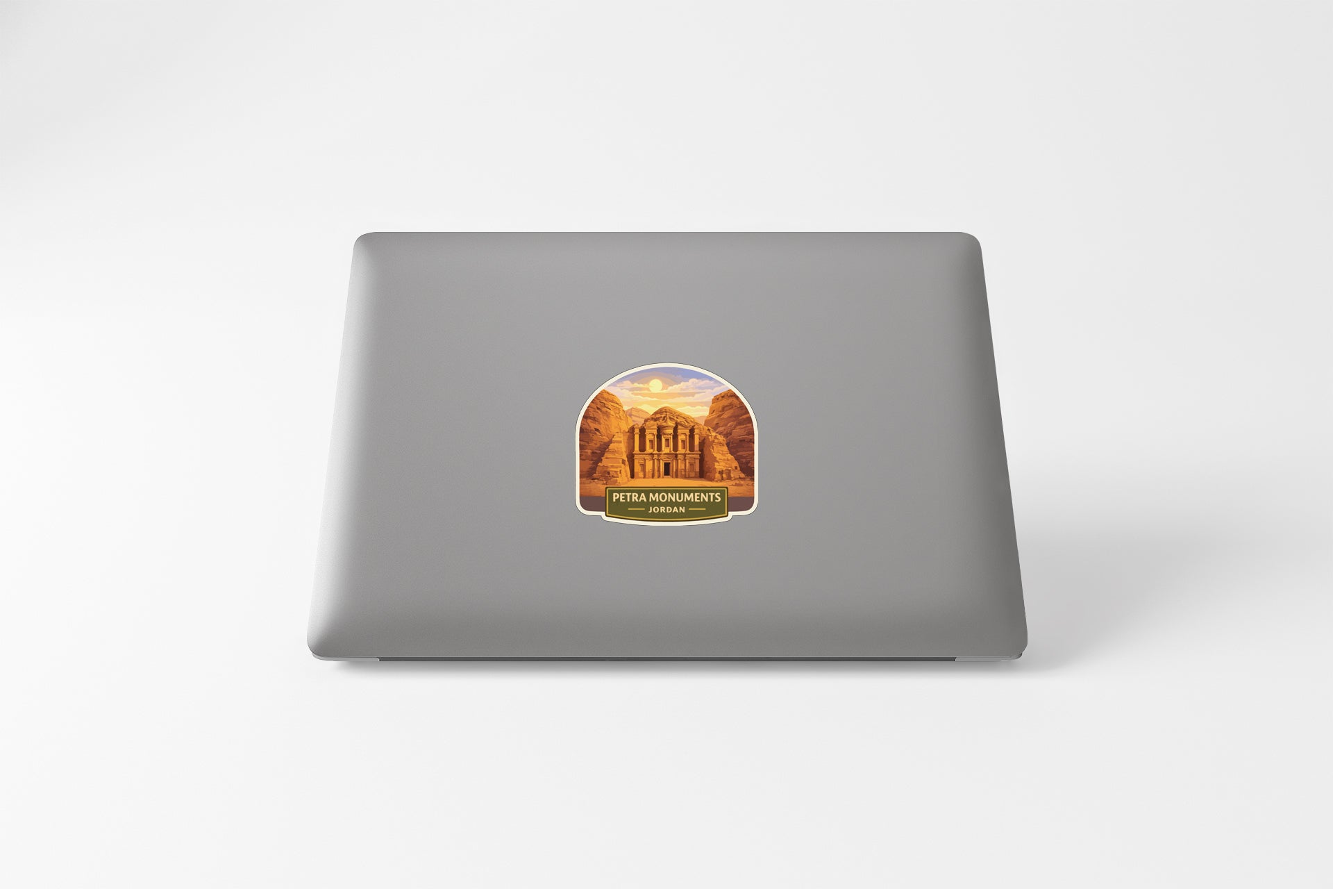 a sticker with an illustration of a building, likely a landmark, on the back of a laptop computer.