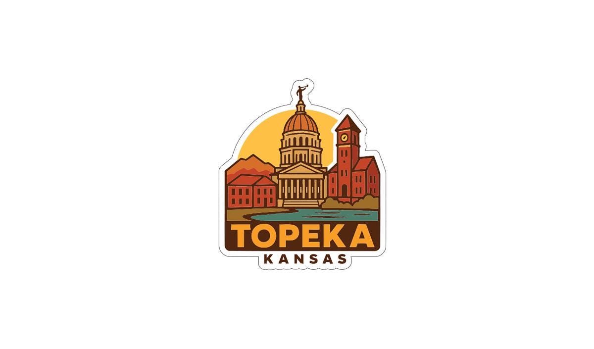 A sticker or logo depicting the state of Kansas with a stylized illustration of the state's capitol building and surrounding buildings.