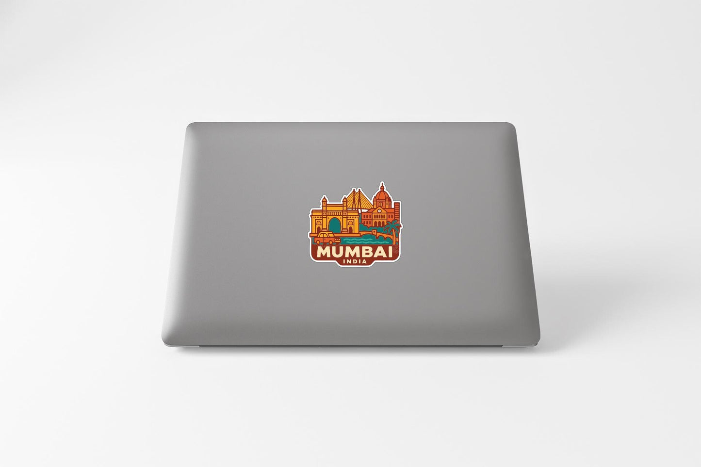 a sticker of the Mumbai skyline on the back of a laptop.