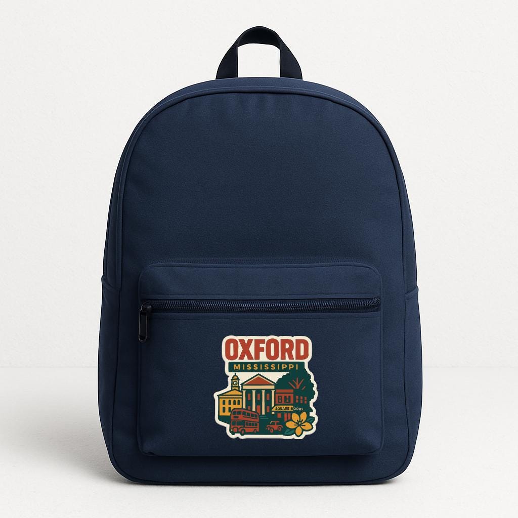 A navy blue backpack with a graphic of Oxford University on the front pocket.