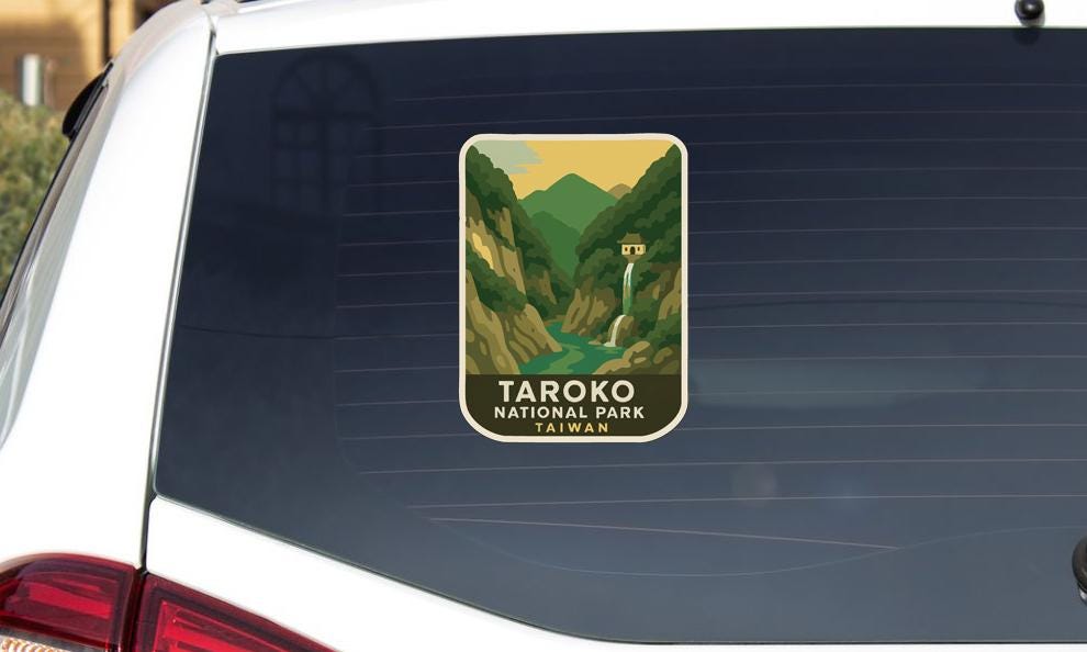 A sticker on the rear window of a car that says "TAROKO NATIONAL PARK TAIWAN".