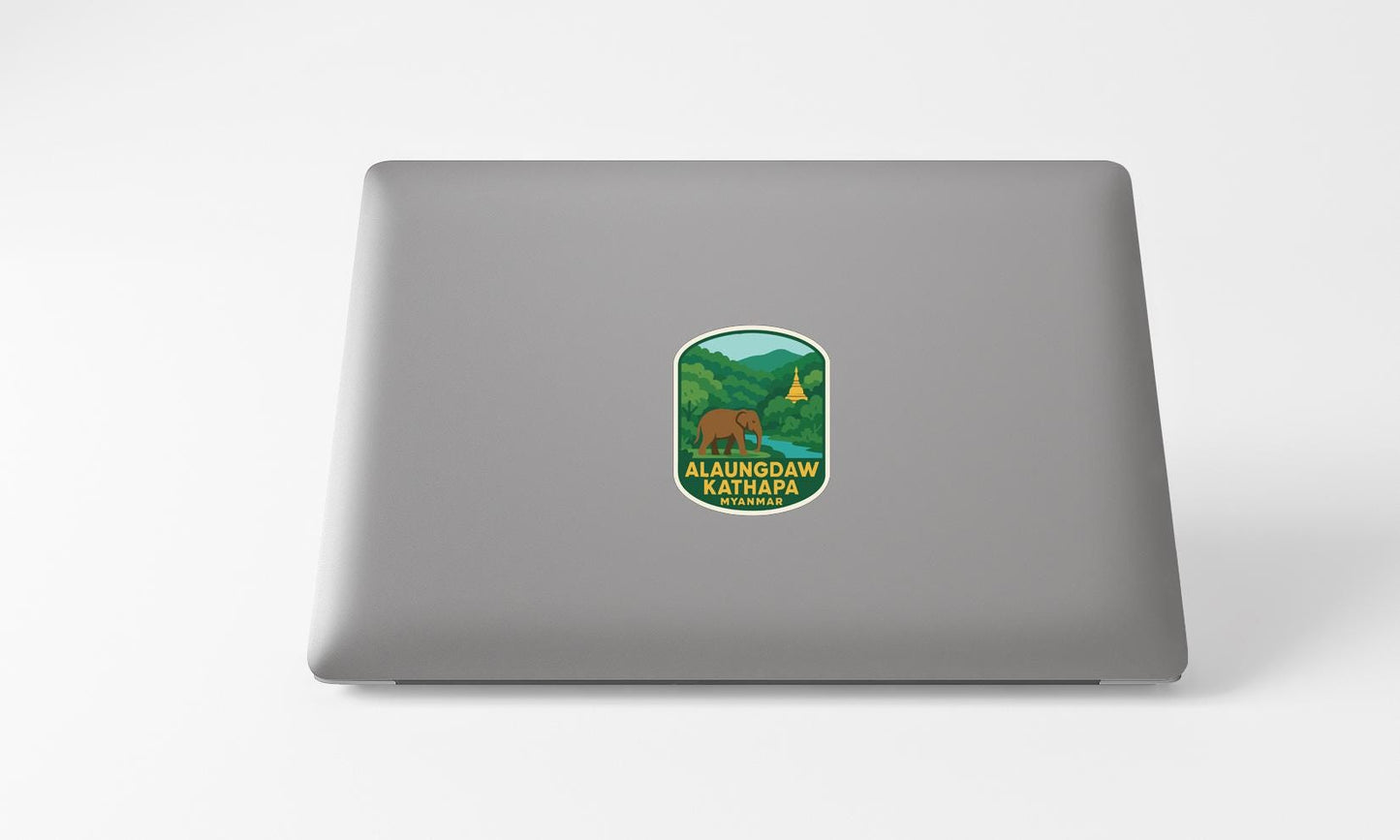 a sticker on the back of a laptop, depicting a bear in a forest setting.
