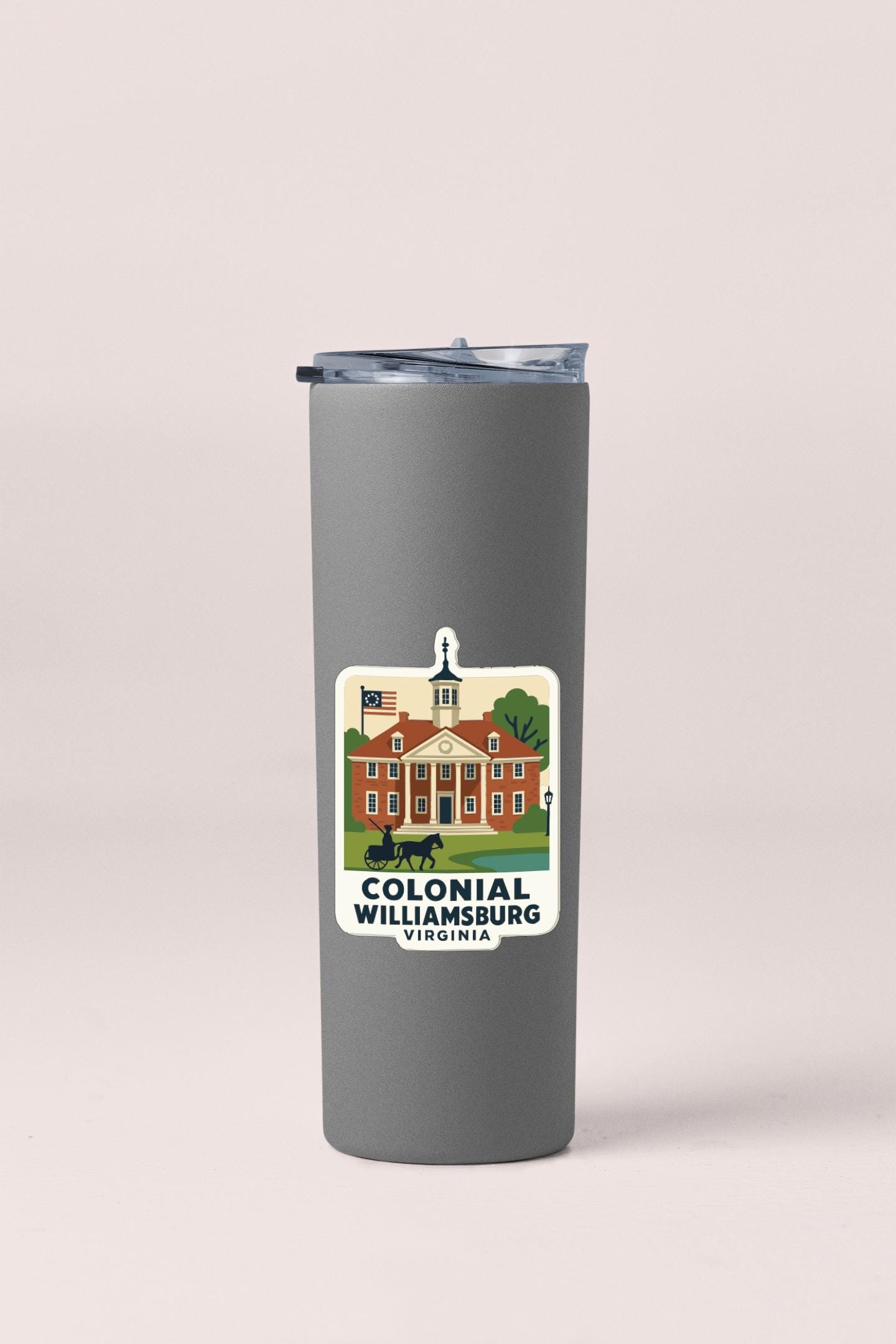 A gray insulated tumbler with a label depicting the Colonial Williamsburg, Virginia, building.