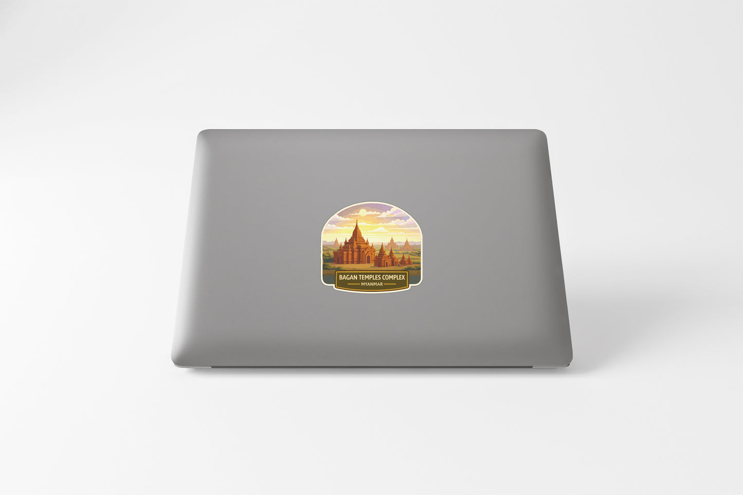 a sticker with a graphic of a temple or monument, placed on the back of a laptop computer.
