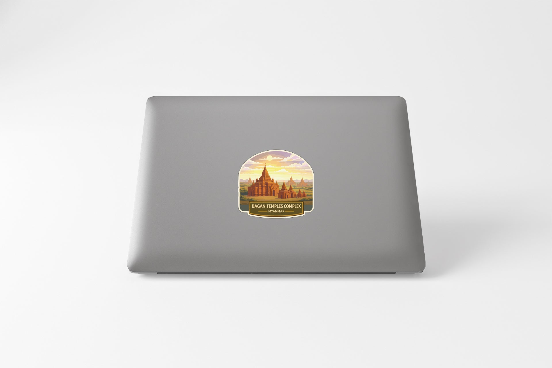 a sticker with a graphic of a temple or monument, placed on the back of a laptop computer.