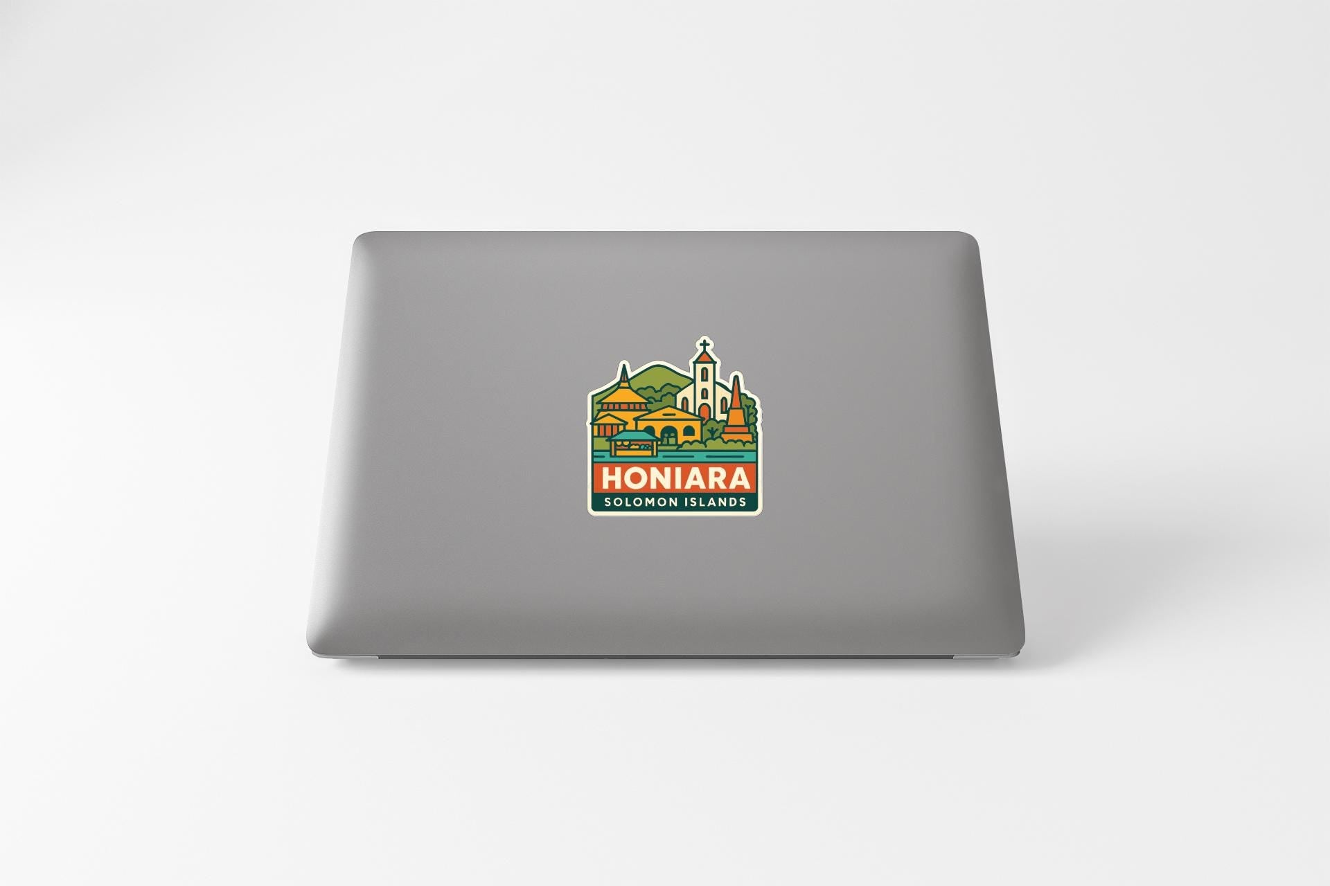 a sticker with a graphic of a town or village, along with the text "HONIARA SOLOMON ISLANDS".