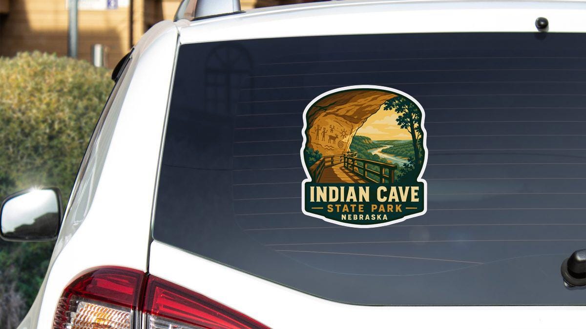 A sticker on the rear window of a vehicle, depicting a scenic view of the Indian Cave State Park in Nebraska.
