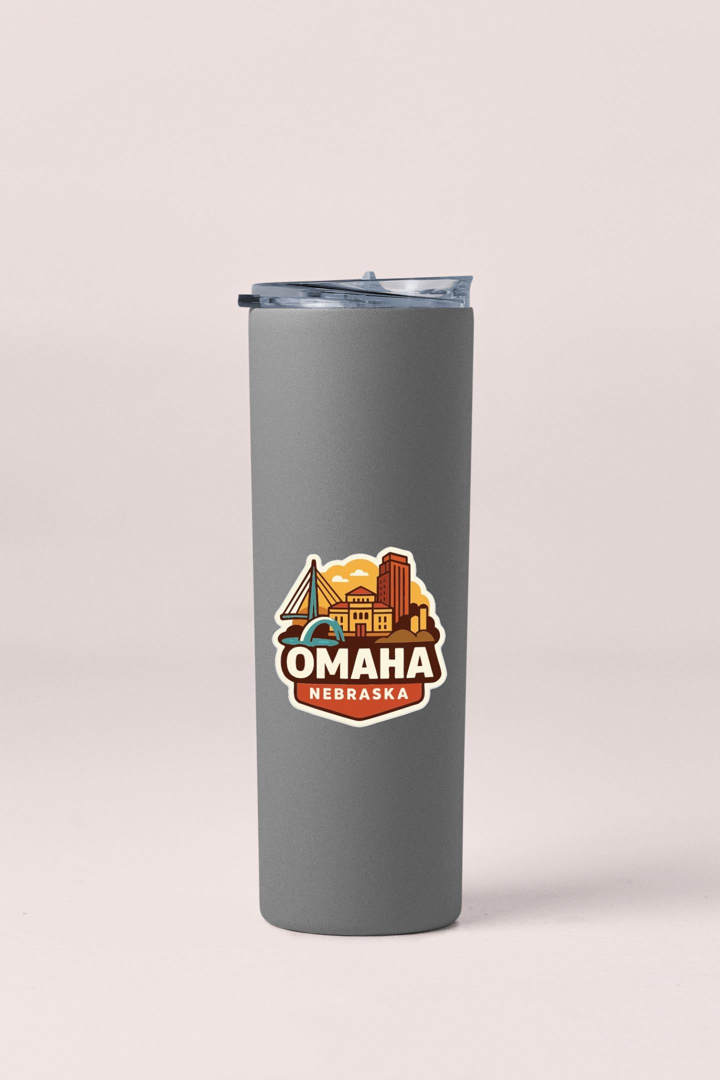A gray insulated tumbler with a printed design of the Omaha, Nebraska skyline.
