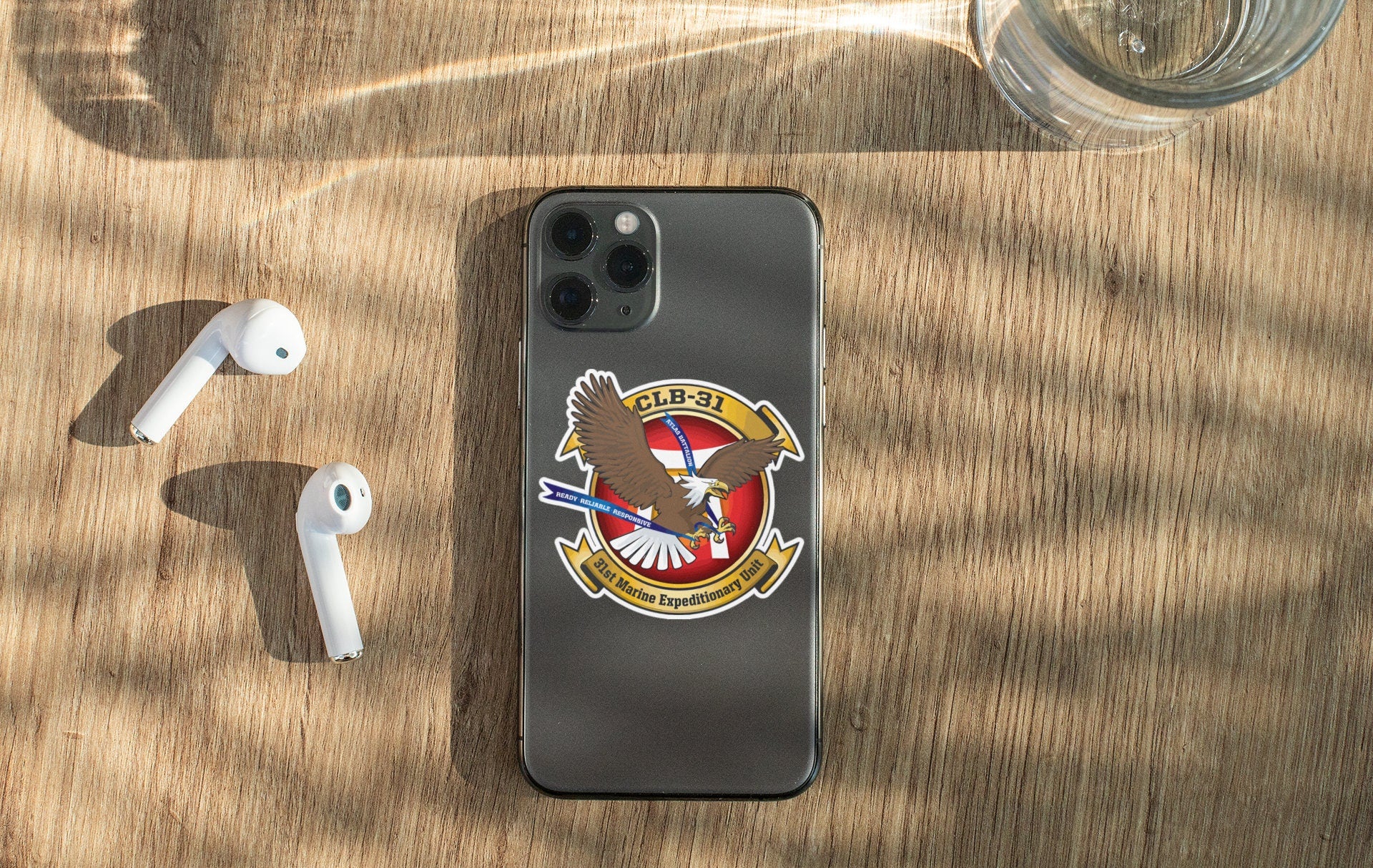 a phone with a us army emblem next to ear buds