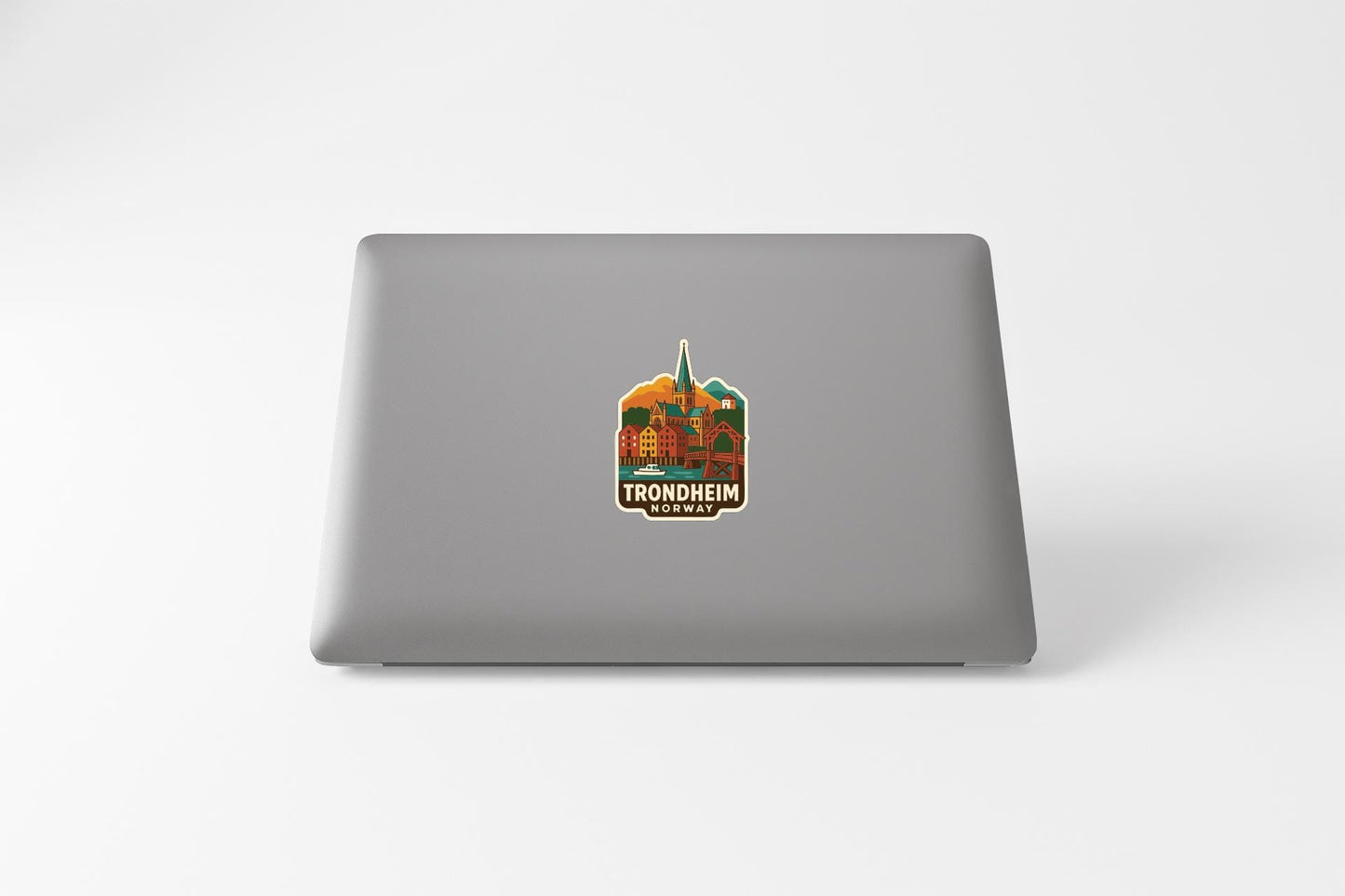 a sticker with a graphic of a building and the text "TRONDHEIM NORWAY" on the back of a laptop.