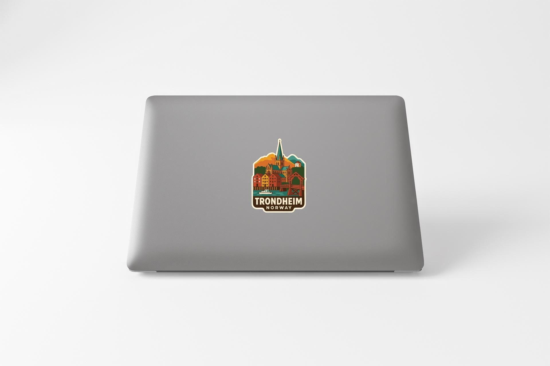 a sticker with a graphic of a building and the text "TRONDHEIM NORWAY" on the back of a laptop.